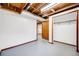 Finished basement area with neutral walls, gray floors, closet, and wooden trim at 1549 S Evanston St, Aurora, CO 80012