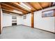 Open basement area showcasing bright lighting, shelving, and clean, painted walls at 1549 S Evanston St, Aurora, CO 80012