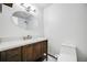 Bathroom features a vanity with storage, white countertops, and an oval mirror at 1549 S Evanston St, Aurora, CO 80012