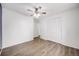 Bright bedroom with wood-look floors, a ceiling fan, and ample closet space at 1549 S Evanston St, Aurora, CO 80012