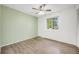 Bedroom features wood-look floors, a ceiling fan, and a bright window for natural light at 1549 S Evanston St, Aurora, CO 80012
