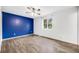 Bedroom featuring wood-look floors, a ceiling fan, and a bright window for natural light at 1549 S Evanston St, Aurora, CO 80012