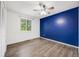 Bedroom featuring wood-look floors, a ceiling fan, and a bright window for natural light at 1549 S Evanston St, Aurora, CO 80012