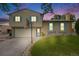 Charming home with a two-car garage, a basketball hoop, and blue shutters under a sky filled with sunset colors at 1549 S Evanston St, Aurora, CO 80012