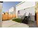View of the backyard featuring manicured lawn, wooden privacy fence, and stairs to building entrance at 3435 W 17Th Ave, Denver, CO 80204