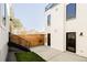 View of backyard showing exterior facade, wooden fence, small garden, and staircase to building entry at 3435 W 17Th Ave, Denver, CO 80204