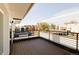 Outdoor balcony with wood flooring and iron railing, offering a view of the surrounding neighborhood at 3435 W 17Th Ave, Denver, CO 80204