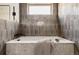 Tranquil bathroom featuring a luxurious soaking tub with stylish tiling, inviting relaxation and serenity, a perfect retreat at 3435 W 17Th Ave, Denver, CO 80204