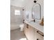 Modern bathroom with tiled shower-tub combination, contemporary vanity, and stylish arched mirror at 3435 W 17Th Ave, Denver, CO 80204