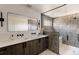 Spa-like bathroom with a double vanity, elegant mirror, modern fixtures, and a glass-enclosed shower at 3435 W 17Th Ave, Denver, CO 80204