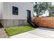 Modern exterior features a well-maintained lawn, metal stair railing, and wood fence for privacy at 3435 W 17Th Ave, Denver, CO 80204