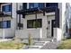 Modern home's entrance with clean lines, featuring a covered porch and well-maintained landscaping at 3435 W 17Th Ave, Denver, CO 80204