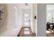 Well-lit hallway featuring hardwood floors, clean lines, and a glimpse into an adjacent room at 3435 W 17Th Ave, Denver, CO 80204