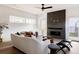 Modern living room with a striking fireplace, contemporary furnishings, and ample natural light at 3435 W 17Th Ave, Denver, CO 80204