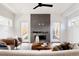 Bright living room with modern fireplace, ceiling fan, and access to outdoor space through glass doors at 3435 W 17Th Ave, Denver, CO 80204