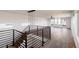 Contemporary staircase with black railings leading to an open living area with hardwood floors and balcony access at 3435 W 17Th Ave, Denver, CO 80204