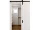 Organized walk-in closet with custom shelving and ample storage, complemented by a sliding barn door, maximizing space at 3435 W 17Th Ave, Denver, CO 80204