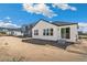 New home backyard featuring a white exterior with dark trim and sliding glass doors leading to the patio at 13575 E 110Th Ln, Commerce City, CO 80022