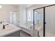 Bright bathroom with double vanity, tub, and glass shower showcasing modern fixtures and stylish design at 13575 E 110Th Ln, Commerce City, CO 80022