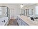 Well-lit bathroom features a double vanity, large mirror, and separate glass shower, offering a luxurious feel at 13575 E 110Th Ln, Commerce City, CO 80022