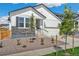 White, two-story home boasting a well-maintained front yard and a two-car garage at 13575 E 110Th Ln, Commerce City, CO 80022
