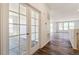 Hallway features striking dark wood flooring and beautiful French doors leading into another room at 13575 E 110Th Ln, Commerce City, CO 80022