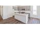 Modern kitchen with gray cabinets, quartz countertops, and a functional island at 13575 E 110Th Ln, Commerce City, CO 80022