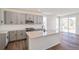 Modern kitchen features gray cabinets, stainless steel appliances, quartz counters and an island with a sink at 13575 E 110Th Ln, Commerce City, CO 80022