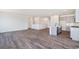 Spacious living area featuring hardwood floors and an open layout to the kitchen at 13575 E 110Th Ln, Commerce City, CO 80022