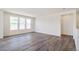Bright living room featuring hardwood floors and multiple windows at 13575 E 110Th Ln, Commerce City, CO 80022