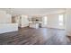 Bright, spacious living room with modern wood flooring and an open floor plan at 13575 E 110Th Ln, Commerce City, CO 80022