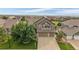 Beautiful aerial view of a two-story home, featuring a three-car garage and a well-manicured lawn at 11691 Riverdale Dr, Parker, CO 80138