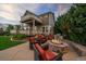 Inviting backyard patio with stone fire pit, outdoor seating, built-in grill, and spacious deck at 11691 Riverdale Dr, Parker, CO 80138