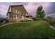 Beautifully landscaped backyard with a large lawn, patio, and mature trees at 11691 Riverdale Dr, Parker, CO 80138