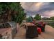 Outdoor patio with a stainless steel BBQ and built-in seating around a fire pit at 11691 Riverdale Dr, Parker, CO 80138