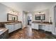 Large bathroom with dual vanities, tile floor, and doorway to the walk-in closet at 11691 Riverdale Dr, Parker, CO 80138