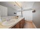 Bright bathroom features double sinks, wooden cabinets, and lots of counterspace at 11691 Riverdale Dr, Parker, CO 80138