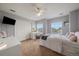 Light-filled bedroom features modern decor, closet, and sun-filled windows at 11691 Riverdale Dr, Parker, CO 80138