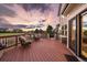 Inviting deck with outdoor seating, manicured lawn, and beautiful sunset views at 11691 Riverdale Dr, Parker, CO 80138