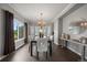 Elegant dining room with large windows, chandelier, and a decorative console table at 11691 Riverdale Dr, Parker, CO 80138