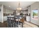 Bright kitchen with gray cabinetry, granite countertops, stainless appliances, and eat-in dining area at 11691 Riverdale Dr, Parker, CO 80138
