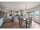 Spacious kitchen with gray cabinetry, granite countertops, and stainless appliances, and adjacent dining area at 11691 Riverdale Dr, Parker, CO 80138