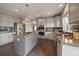 Modern kitchen features gray cabinetry, granite countertops, stainless steel appliances, and an island cooktop at 11691 Riverdale Dr, Parker, CO 80138