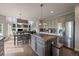Open concept kitchen featuring gray cabinetry, granite countertops, and stainless steel appliances at 11691 Riverdale Dr, Parker, CO 80138