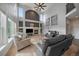 Spacious living room featuring tall ceilings, large windows, a fireplace, and plenty of seating options at 11691 Riverdale Dr, Parker, CO 80138
