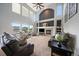 Spacious living room featuring tall ceilings, large windows, a fireplace, and plenty of seating at 11691 Riverdale Dr, Parker, CO 80138