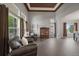 Open-concept living room featuring large windows, tray ceilings, and hardwood floors at 11691 Riverdale Dr, Parker, CO 80138