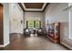 Bright living room with hardwood floors, large windows, and a cozy seating area at 11691 Riverdale Dr, Parker, CO 80138