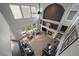 Spacious living room with high ceilings, fireplace, and ample natural light from large windows at 11691 Riverdale Dr, Parker, CO 80138