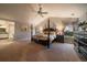 This is a well-lit main bedroom with neutral colors, a ceiling fan and a large bed at 11691 Riverdale Dr, Parker, CO 80138